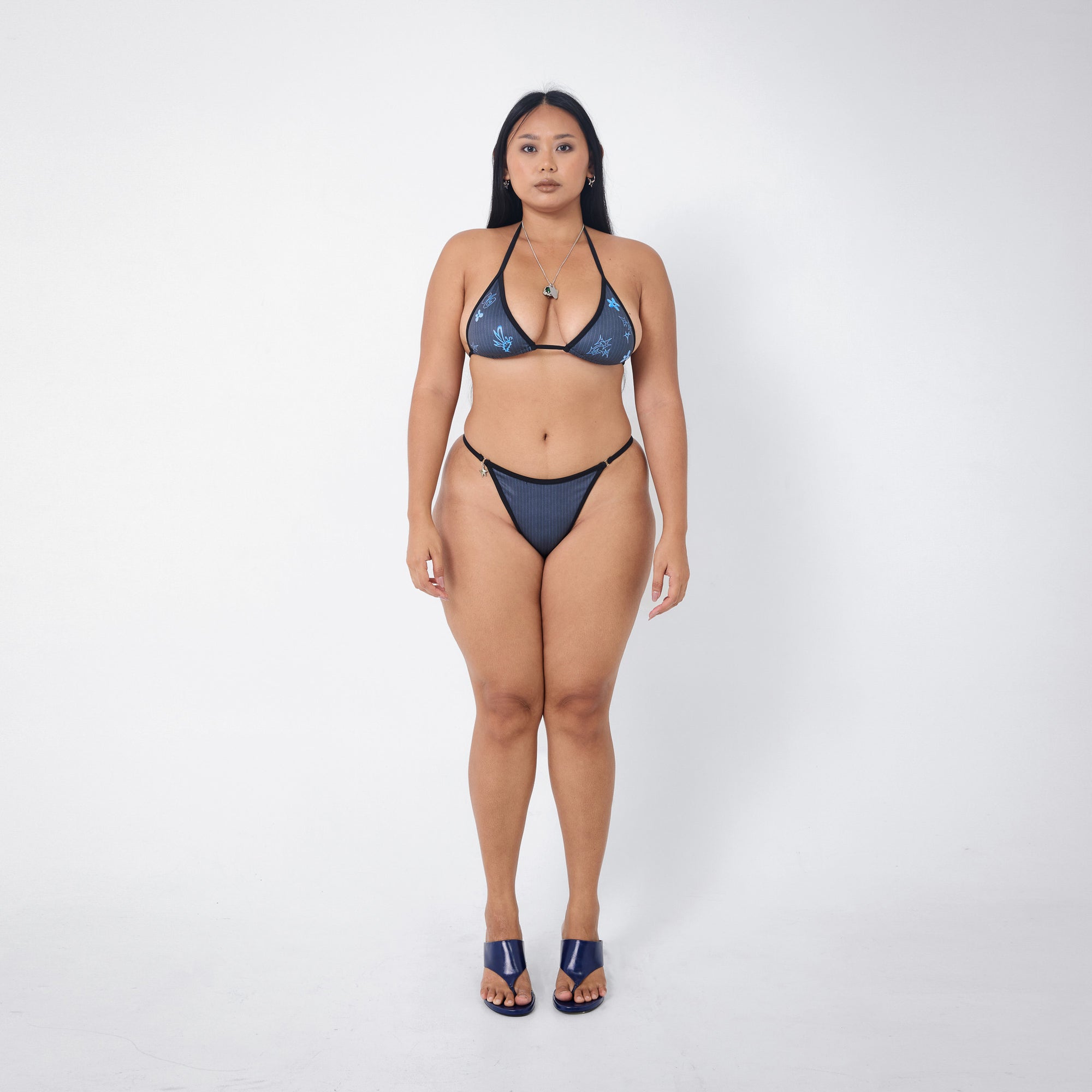 Arthur Apparel strappy bikini bottom in black and blue pinstripe print with silver star charm